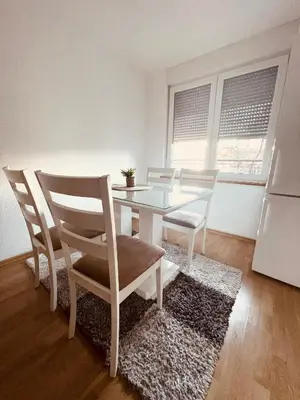 a dining room with a glass table and chairs at Apartman 007 in Jajce