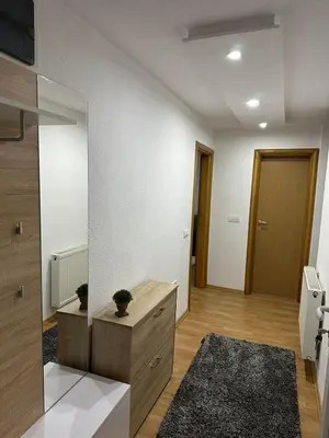 a living room with a dresser and a mirror at Apartman 007 in Jajce