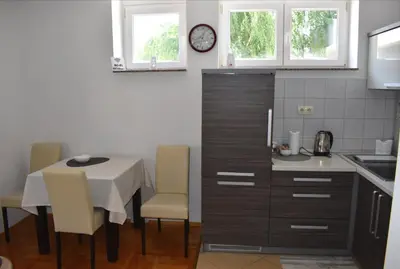 a kitchen with a table and a table and chairs at ViGoSt in Banja Luka