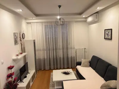 a living room with a couch and a tv at Apartman 888 in Banja Luka