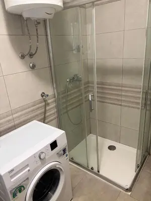 a washing machine in a bathroom with a shower at Apartman 888 in Banja Luka