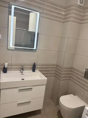 a bathroom with a sink and a toilet and a mirror at Apartman 888 in Banja Luka