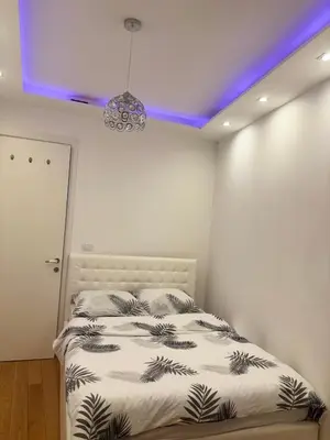 a bedroom with a bed and a purple ceiling at Apartman 888 in Banja Luka