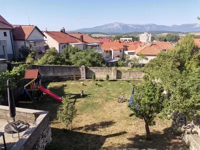a small yard with a playground in a city at VERANIJE Apartman in Livno