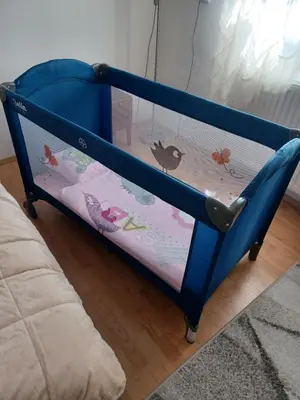 a blue crib with a shelf with animals on it at VERANIJE Apartman in Livno