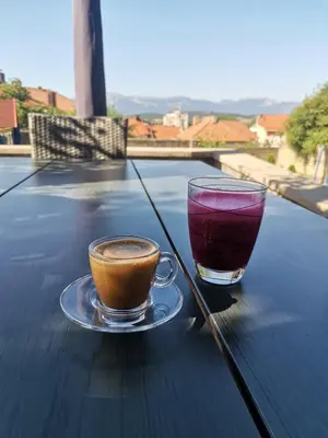 two cups of coffee sitting on top of a wooden table at VERANIJE Apartman in Livno