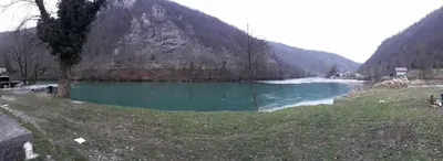 a view of a river with a mountain in the background at Faris in Bihać