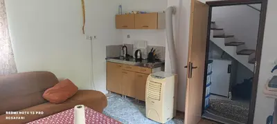 a living room with a couch and a sink and a kitchen at Faris in Bihać