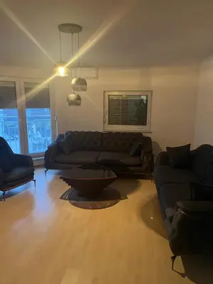 a living room with a couch and a table at Stan Centar in Sanski most