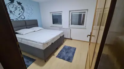 a small bedroom with a bed and a window at Stan Centar in Sanski most