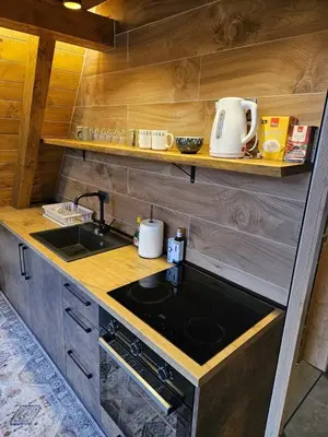 a kitchen with a sink and a stove top oven at Luxury Villa Mašić in Čardaci