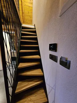 a staircase in a house with wooden floors at Luxury Villa Mašić in Čardaci