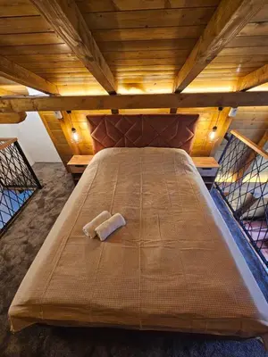 a large bed with two towels on it in a room at Luxury Villa Mašić in Čardaci