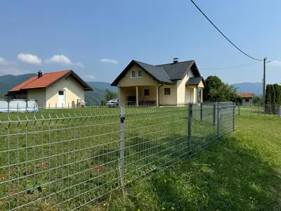 a fence in front of a house at Kuća za odmor- Fojnica in Tješilo