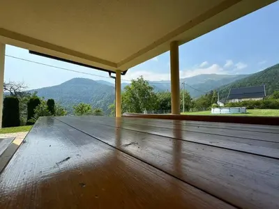 a large wooden deck with a view of mountains at Kuća za odmor- Fojnica in Tješilo