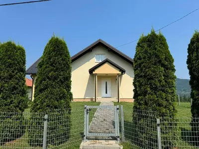 a house with a gate in front of trees at Kuća za odmor- Fojnica in Tješilo