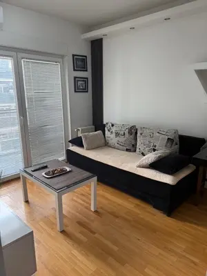 a living room with a couch and a coffee table at Apartmani LUX Tamara in Banja Luka