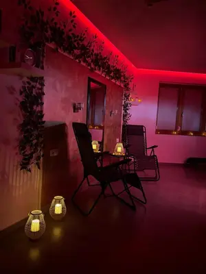 a room with two chairs and a table with red lights at Wellness Spa Hotel Zeleni Raj in Banja Luka