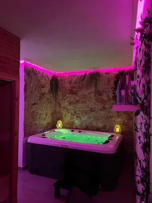a bathroom with a tub with purple lighting at Wellness Spa Hotel Zeleni Raj in Banja Luka