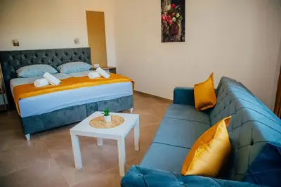 a bedroom with a bed and a couch at Wellness Spa Hotel Zeleni Raj in Banja Luka
