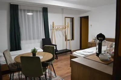 a living room with a couch and a table and a living room at Whispering Pines in Šišava