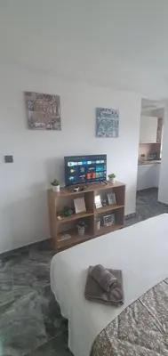 a living room with a couch and a tv at Apartman Katić in Odžak
