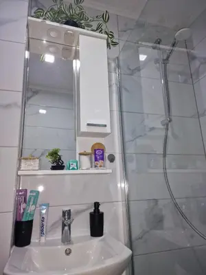 a bathroom with a sink and a shower at Apartman Katić in Odžak