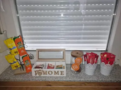 a counter with a box of food and some snacks at Apartman Katić in Odžak