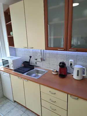 a kitchen counter with a sink and a microwave at Theatre View Banja Luka in Banja Luka
