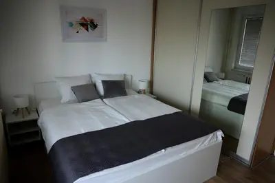 a bedroom with a large bed with a mirror at Theatre View Banja Luka in Banja Luka
