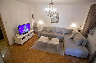 a living room with a couch and a tv at Apartment Barby - Aleja in Banja Luka