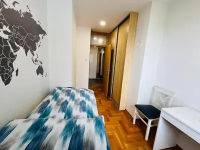 a room with a bed with a world map on the wall at Apartman Tara 11 in Banja Luka
