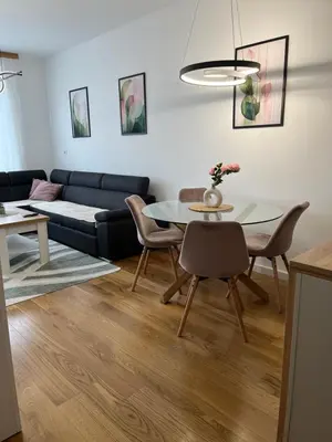a living room with a table and a couch at Apartman Delta in Banja Luka