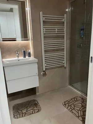 a bathroom with a sink and a shower at Apartman Delta in Banja Luka