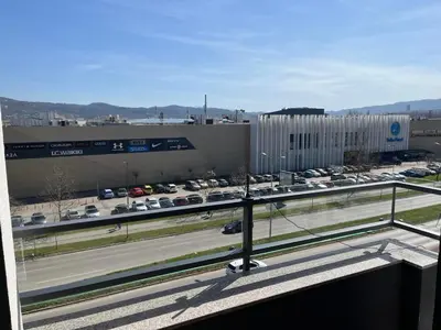a view of a parking lot and a highway with cars at Apartman Delta in Banja Luka
