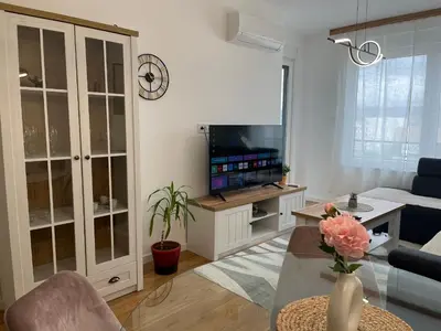 a living room with a couch and a tv at Apartman Delta in Banja Luka