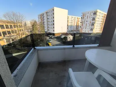 a balcony with a table and a view of a city at Apartman Vanja in Doboj