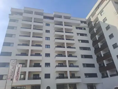 an apartment building with balconies on a sunny day at Apartman Vanja in Doboj