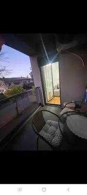 a room with a glass table and chairs and a window at Stan na dan Banja luka Mejdan in Hiseti