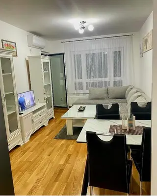 a living room with a couch and a table at Stan na dan Banja luka Mejdan in Hiseti