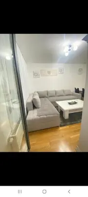 a living room with a couch and a table at Stan na dan Banja luka Mejdan in Hiseti