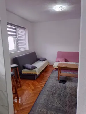a living room with a couch and a table at Apartmani Amina in Bihać