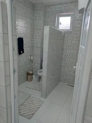 a bathroom with a shower and a toilet at Apartmani Amina in Bihać