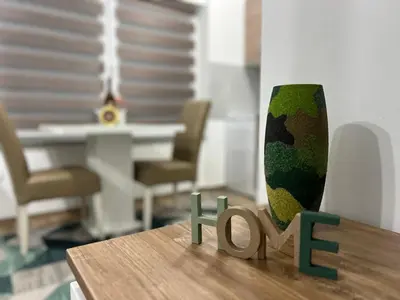 a table with a vase sitting on top of it at Apartman Mrša in Livno