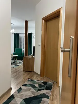 a hallway with a door and a living room at Apartman Mrša in Livno