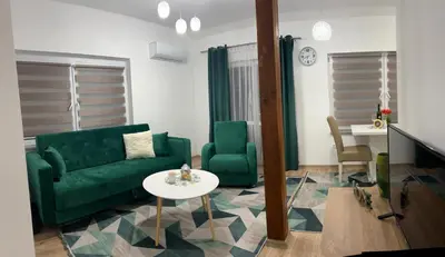 a living room with a green couch and a table at Apartman Mrša in Livno