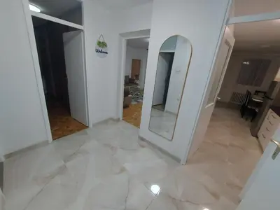 a room with a mirror and a white wall at Apartman Borik in Banja Luka
