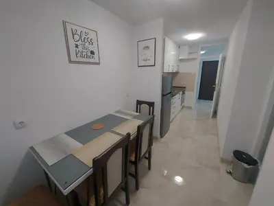 a kitchen and dining room with a table and chairs at Apartman Borik in Banja Luka
