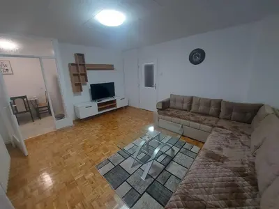 a living room with a couch and a television at Apartman Borik in Banja Luka
