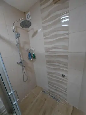 a shower with a glass door in a bathroom at Apartman Borik in Banja Luka